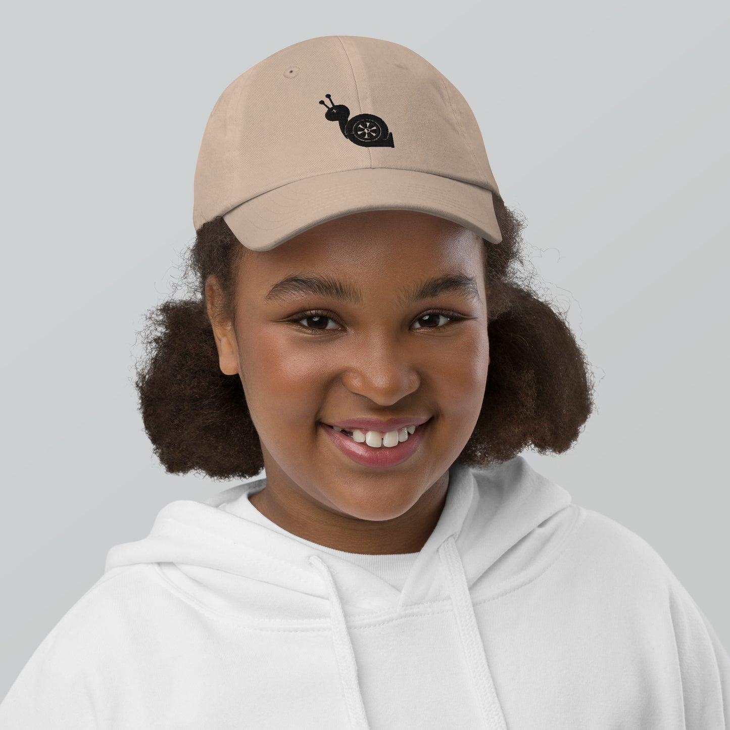 Youth with a khaki baseball cap and a turbo snail print