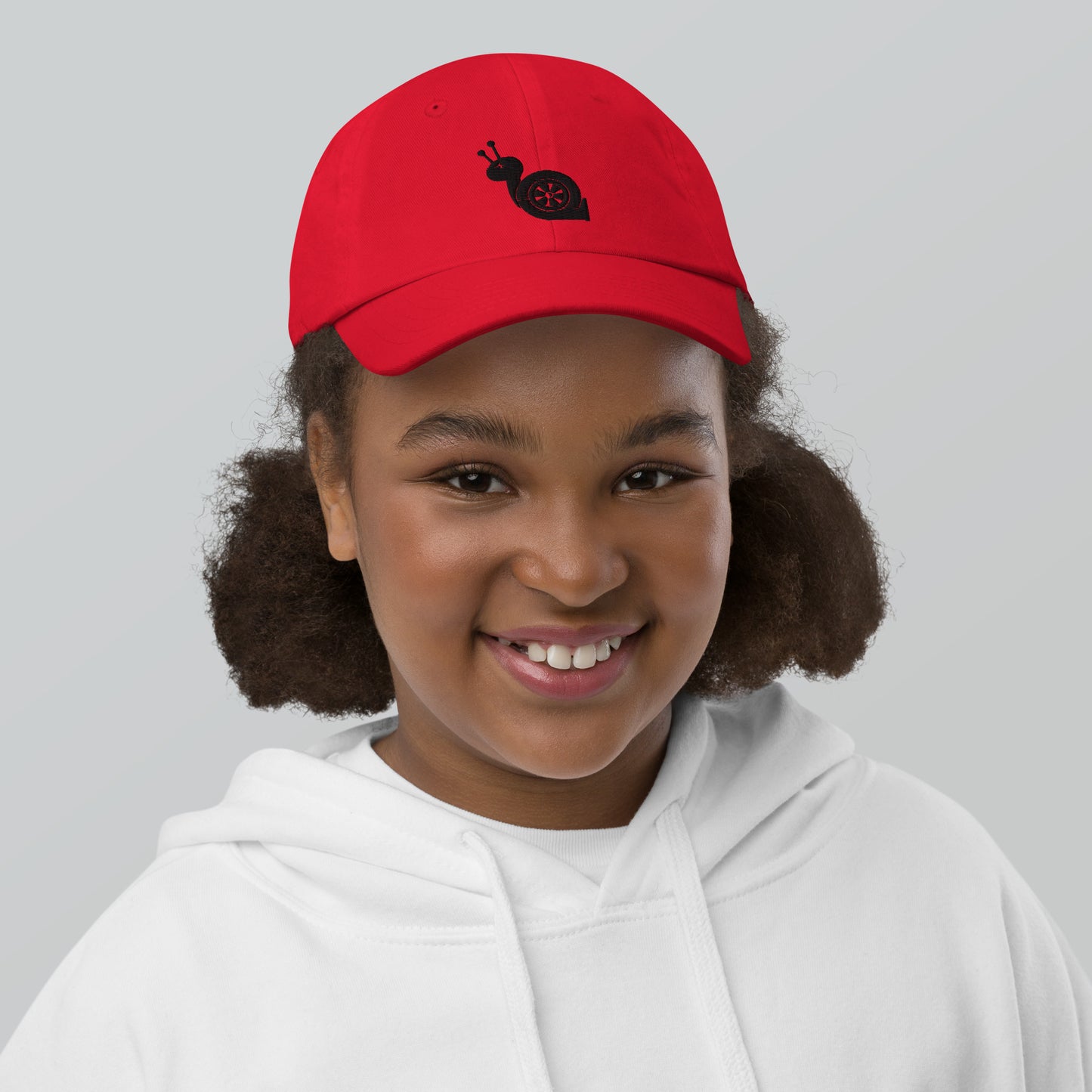 Youth with a red baseball cap and a turbo snail print