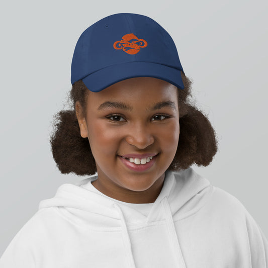 Youth with royal blue baseball cap with a print of a head of a monkey in color brown