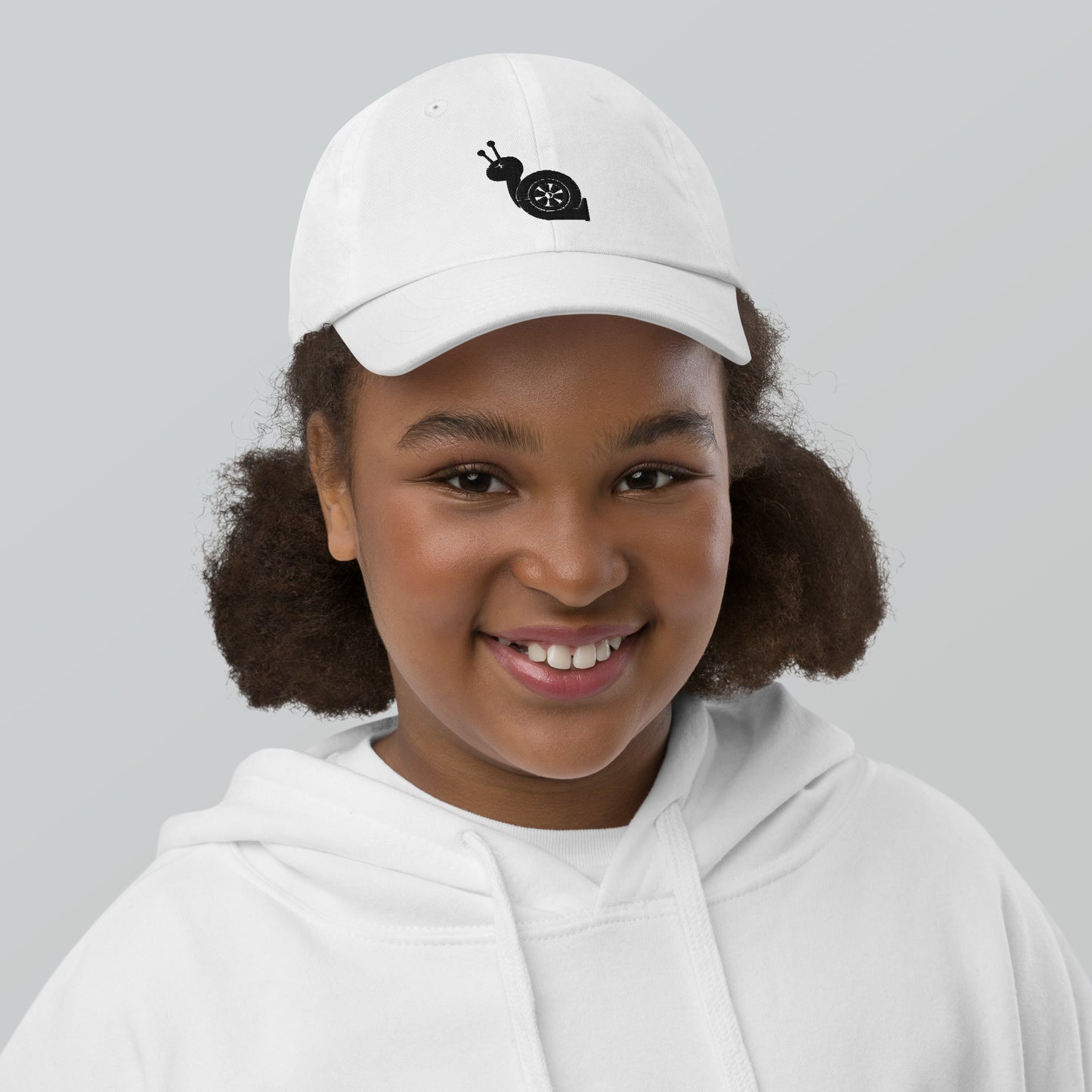 Youth with a white baseball cap and a turbo snail print