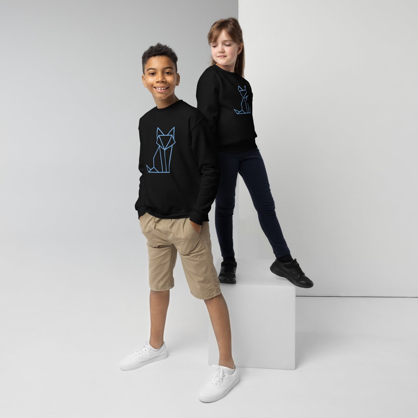 Youth with a black sweatshirt with a print of a fox in blue
