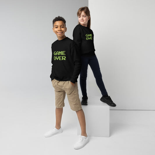 Youth with black sweater with the text GAME OVER in green