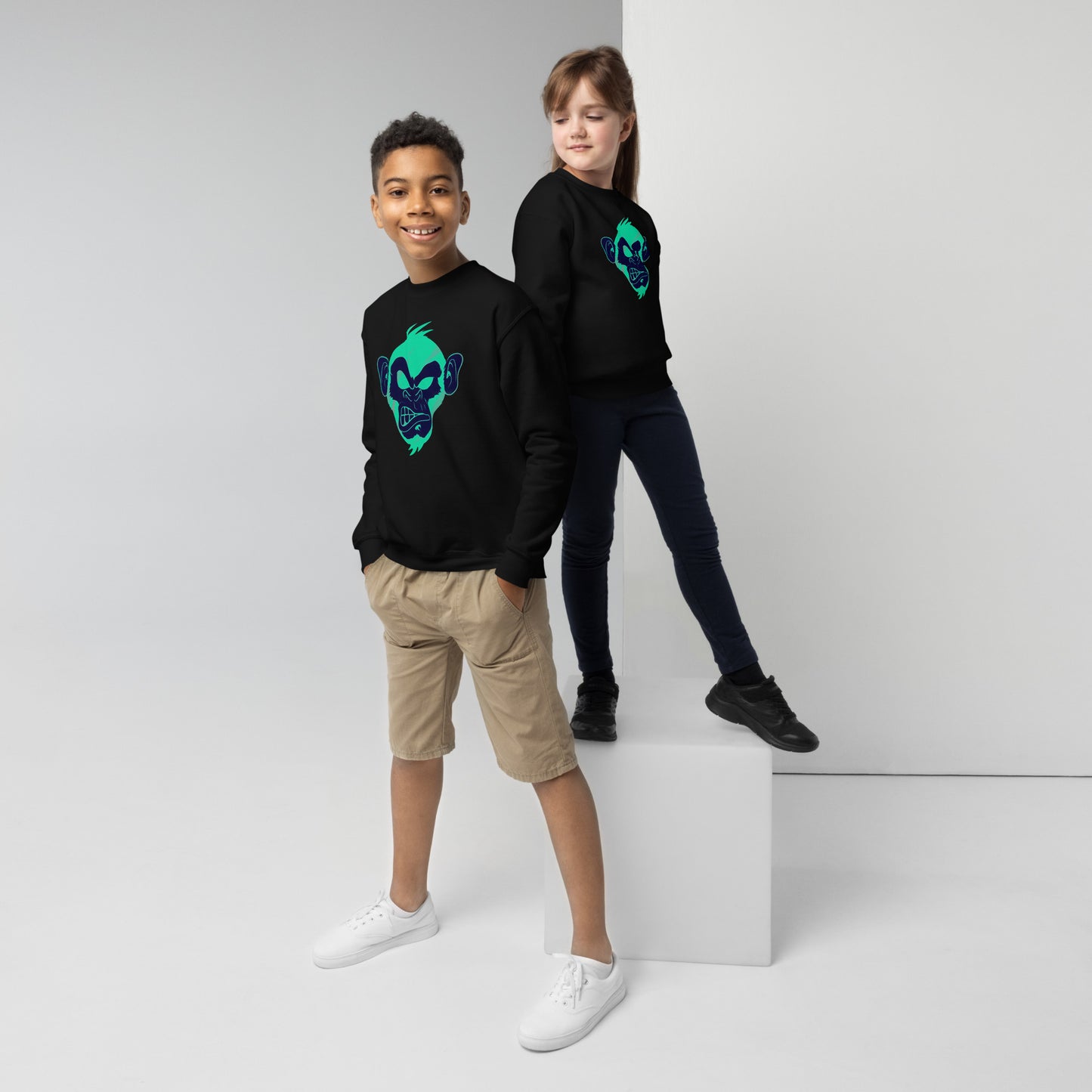 Boy and girl with black sweater and print of a Cool monkey in black light green