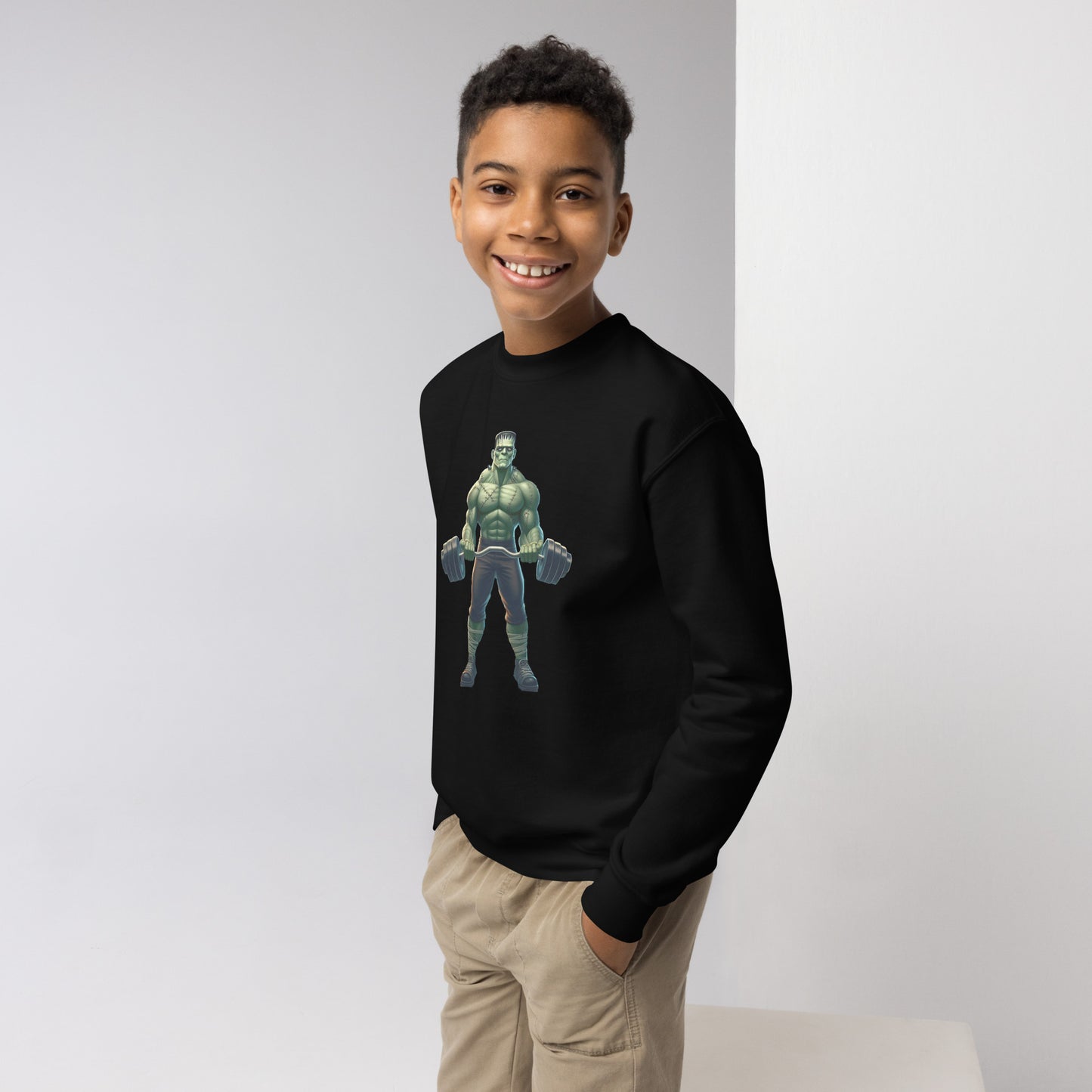 Youth with black sweater with a print of a bodybuilder