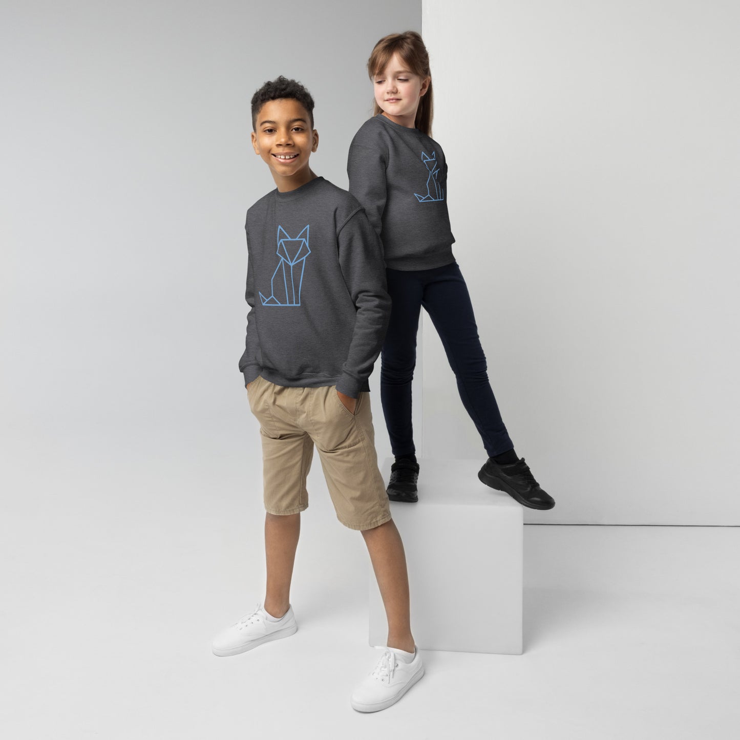 Youth with a dark grey sweatshirt with a print of a fox in blue
