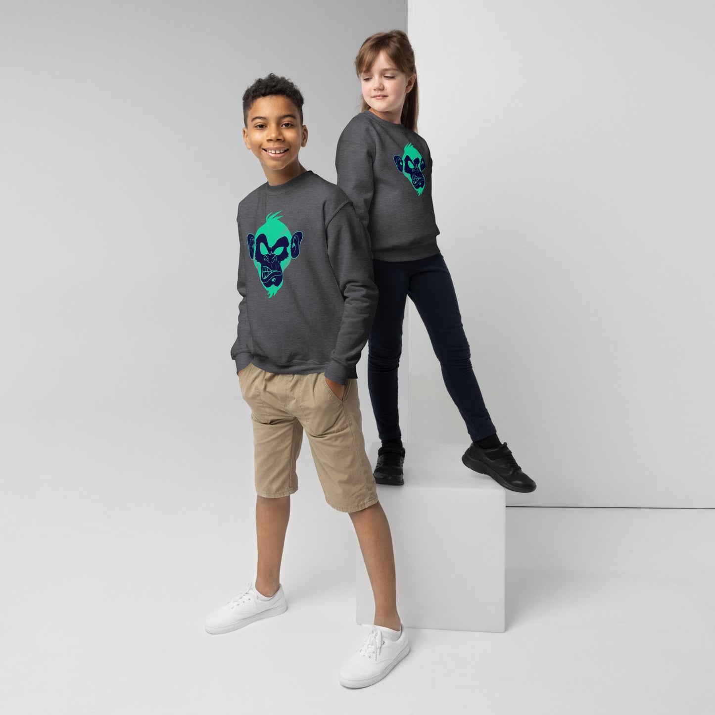 Boy and girl with dark grey sweater and print of a Cool monkey in black light green