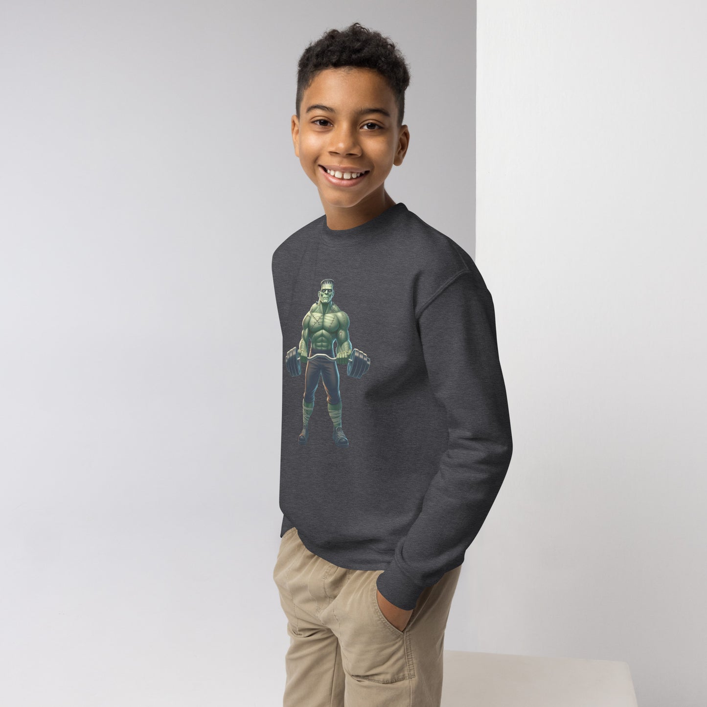 Youth with dark grey sweater with a print of a bodybuilder