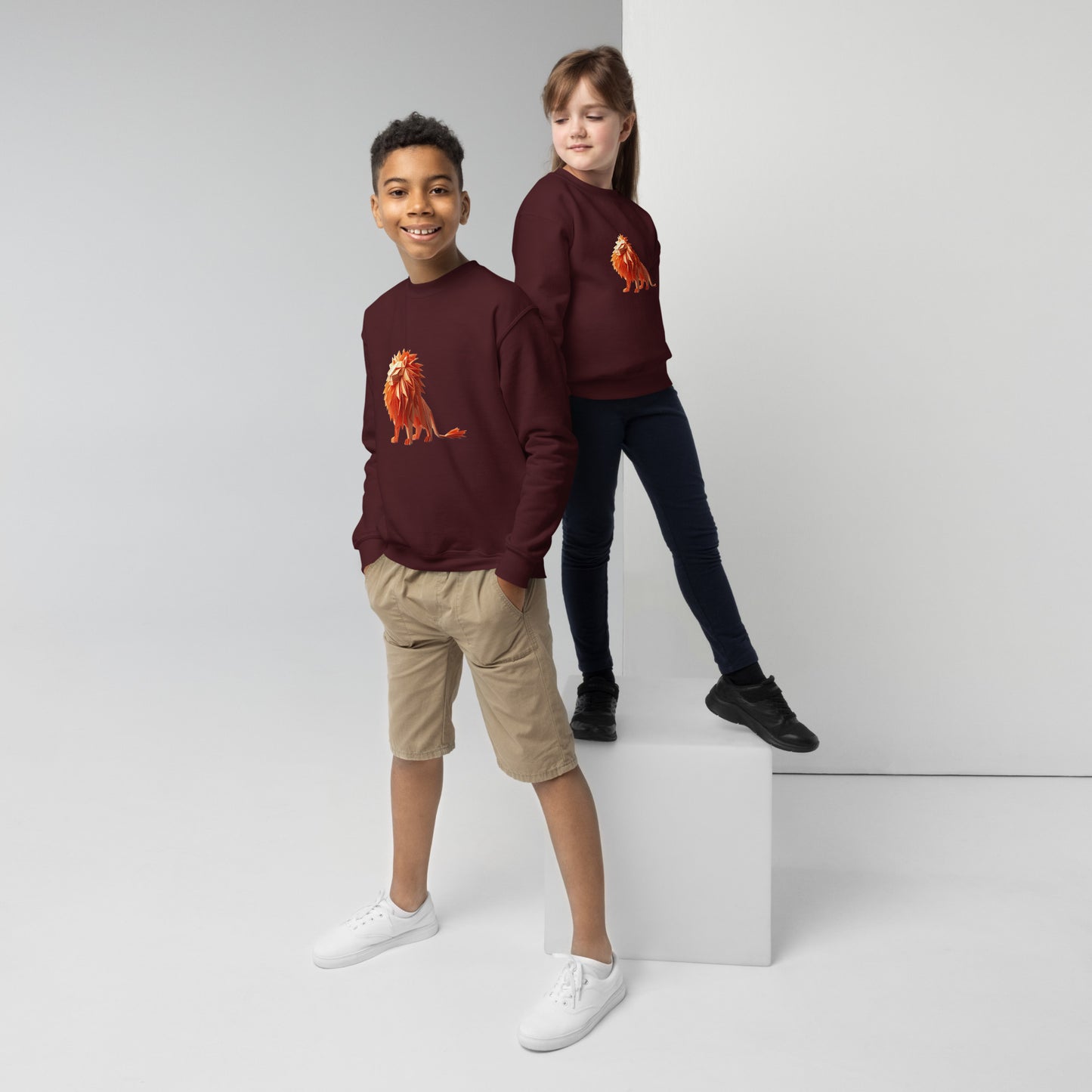 Youth with a maroon sweatshirt with a print of a lion