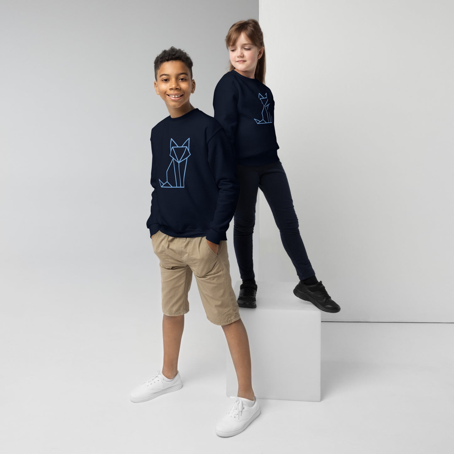 Youth with a navy sweatshirt with a print of a fox in blue