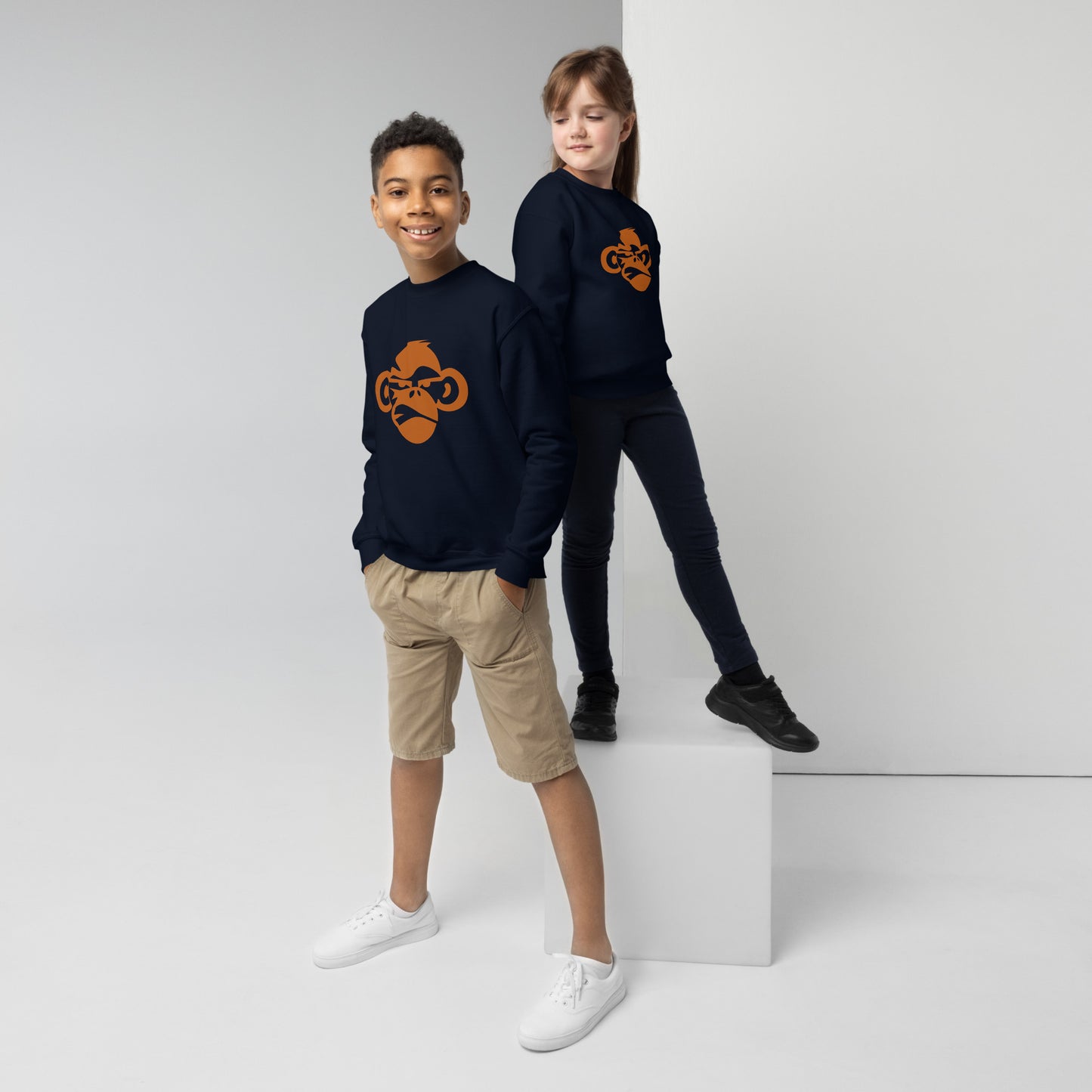 Youth with navy sweatshirt with a print of a head of a monkey in color brown