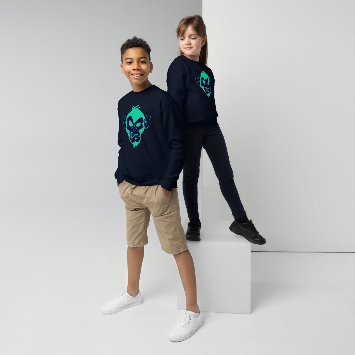 Boy and girl with navy sweater and print of a Cool monkey in black light green
