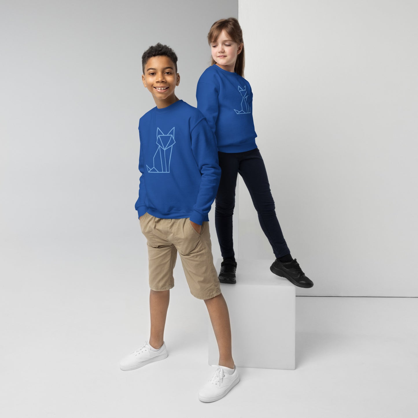 Youth with a royal blue sweatshirt with a print of a fox in blue