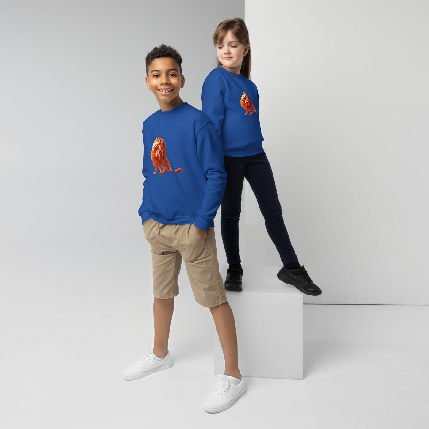 Youth with a royal blue sweatshirt with a print of a lion
