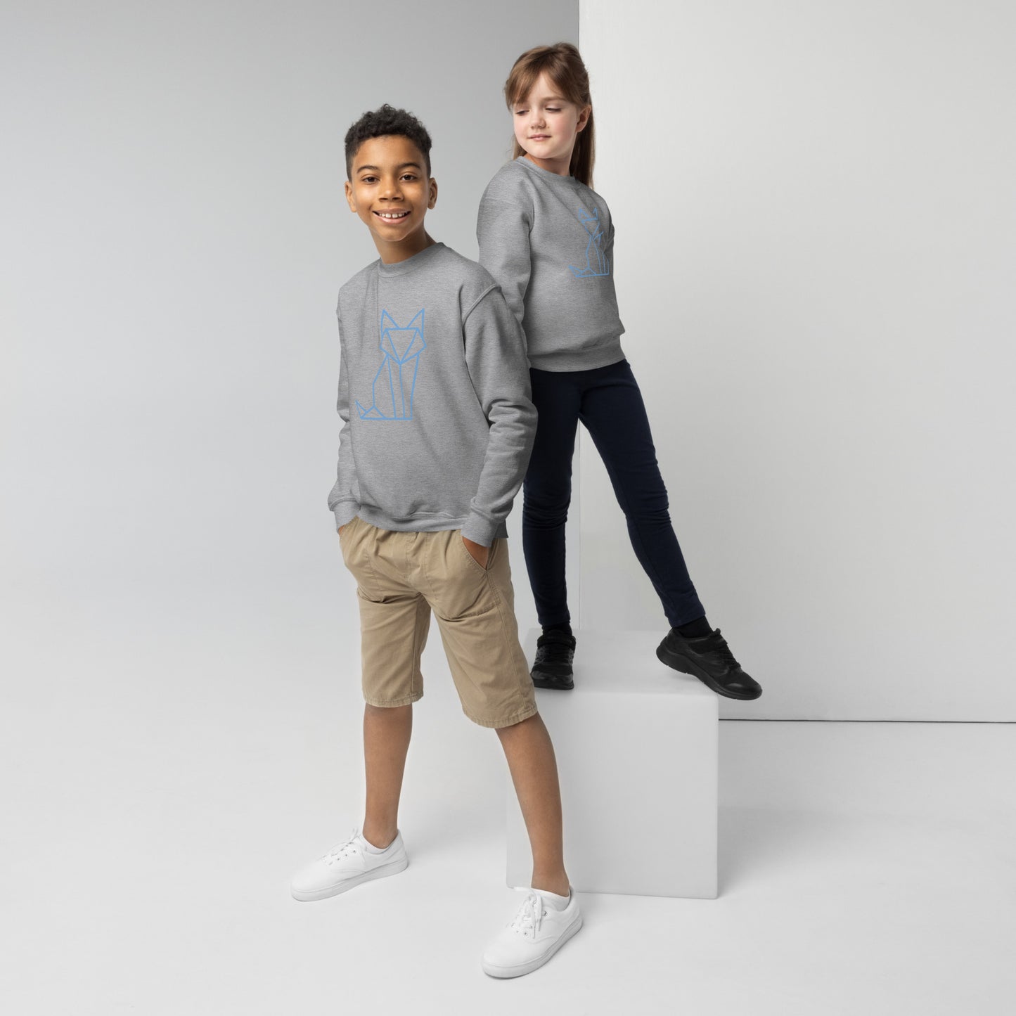 Youth with a sport grey sweatshirt with a print of a fox in blue