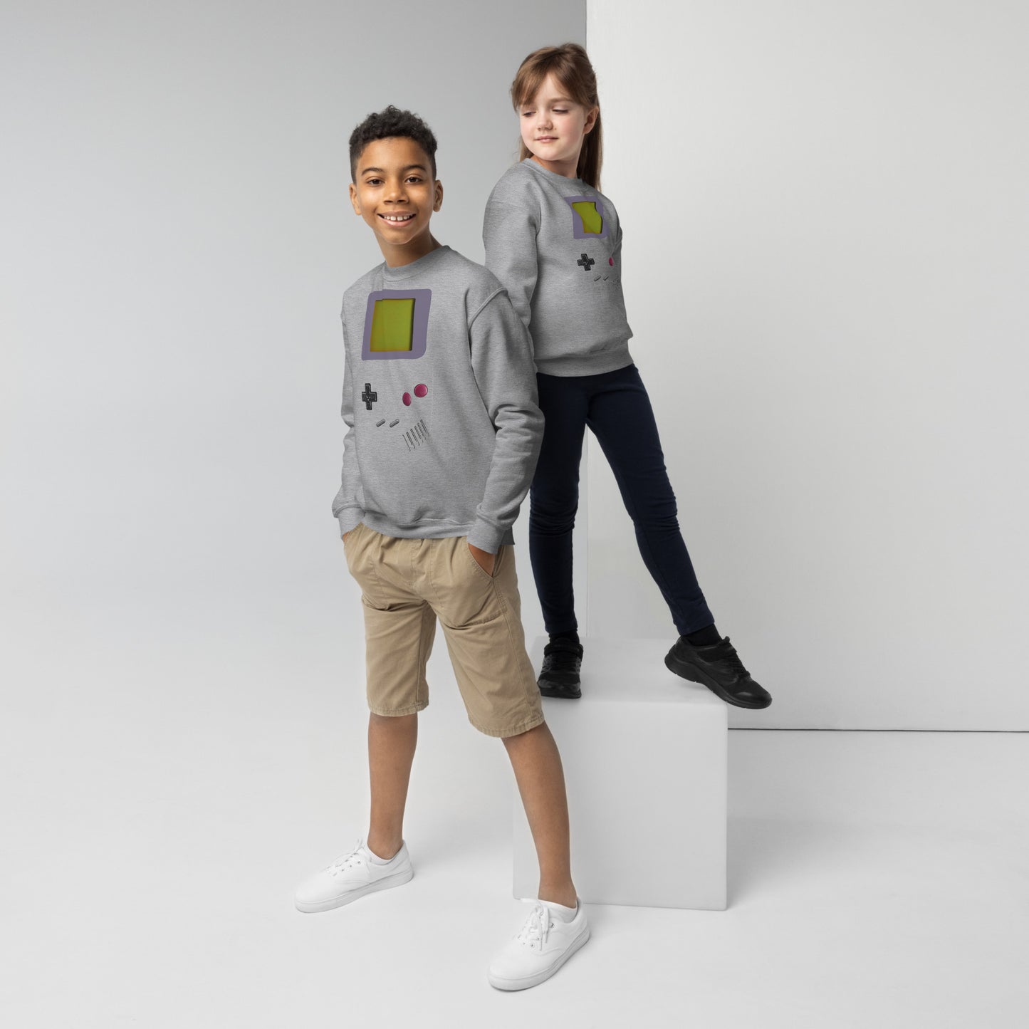 Youth girl and boy with a grey sweatshirt with a print of gameboy