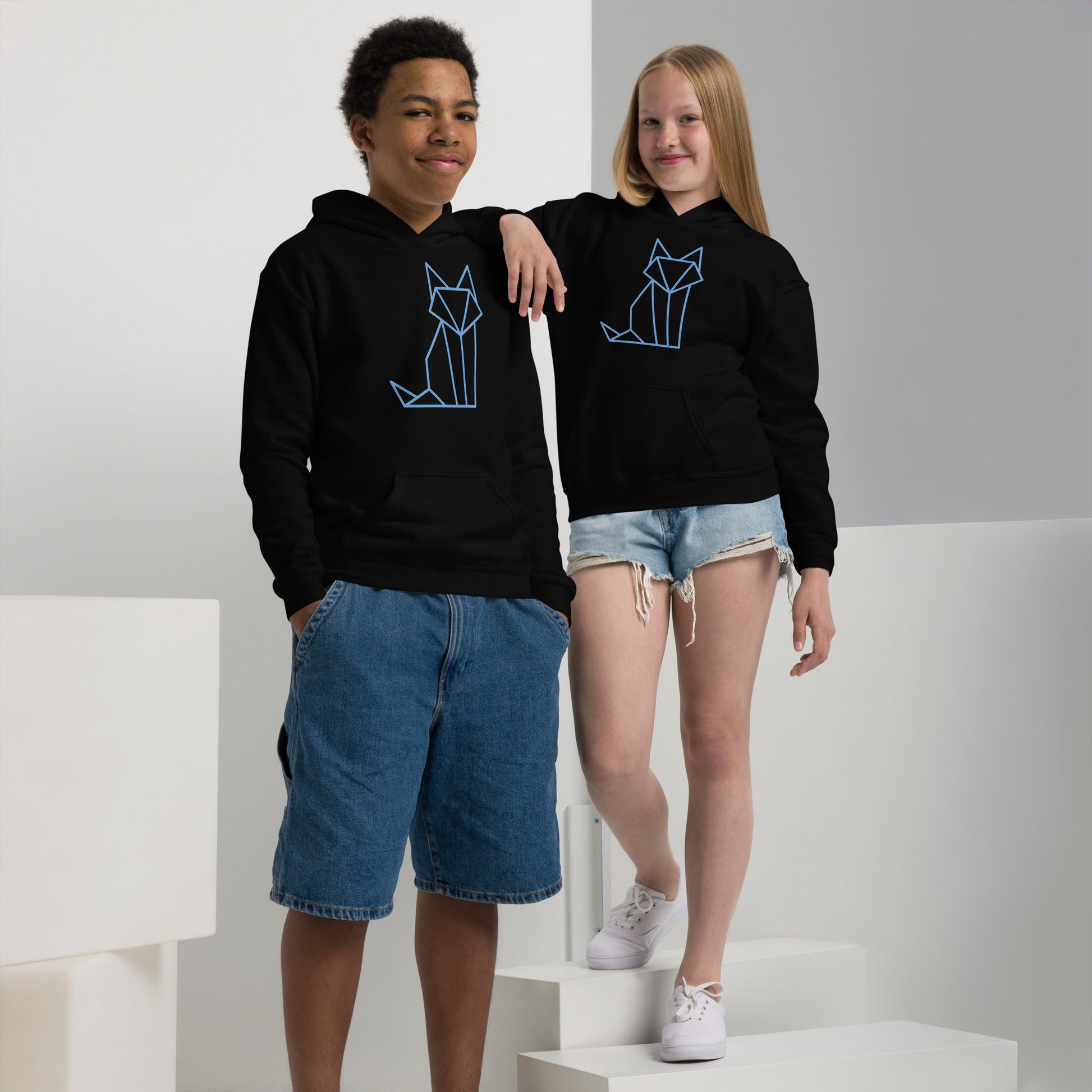 Youth with a black sweatshirt with a print of a fox in blue