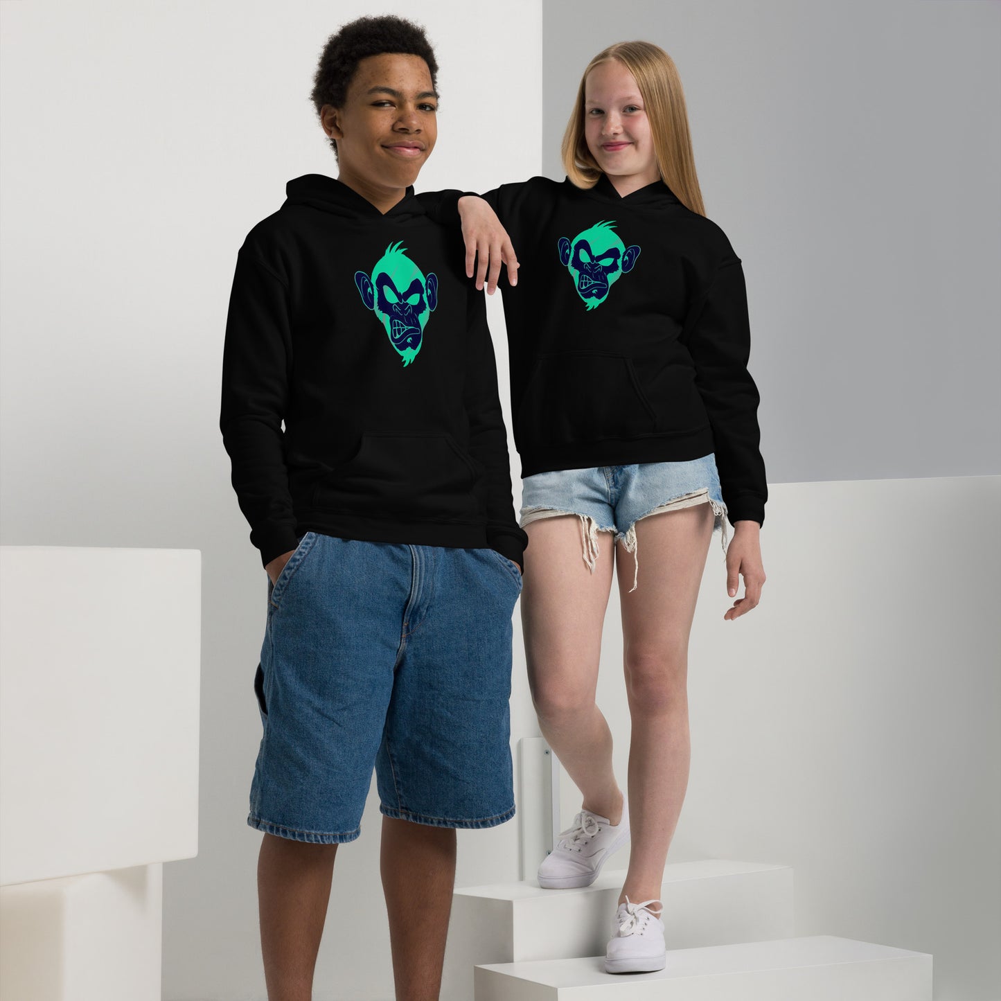 Boy and girl with black hoodie and print of a Cool monkey in black light green