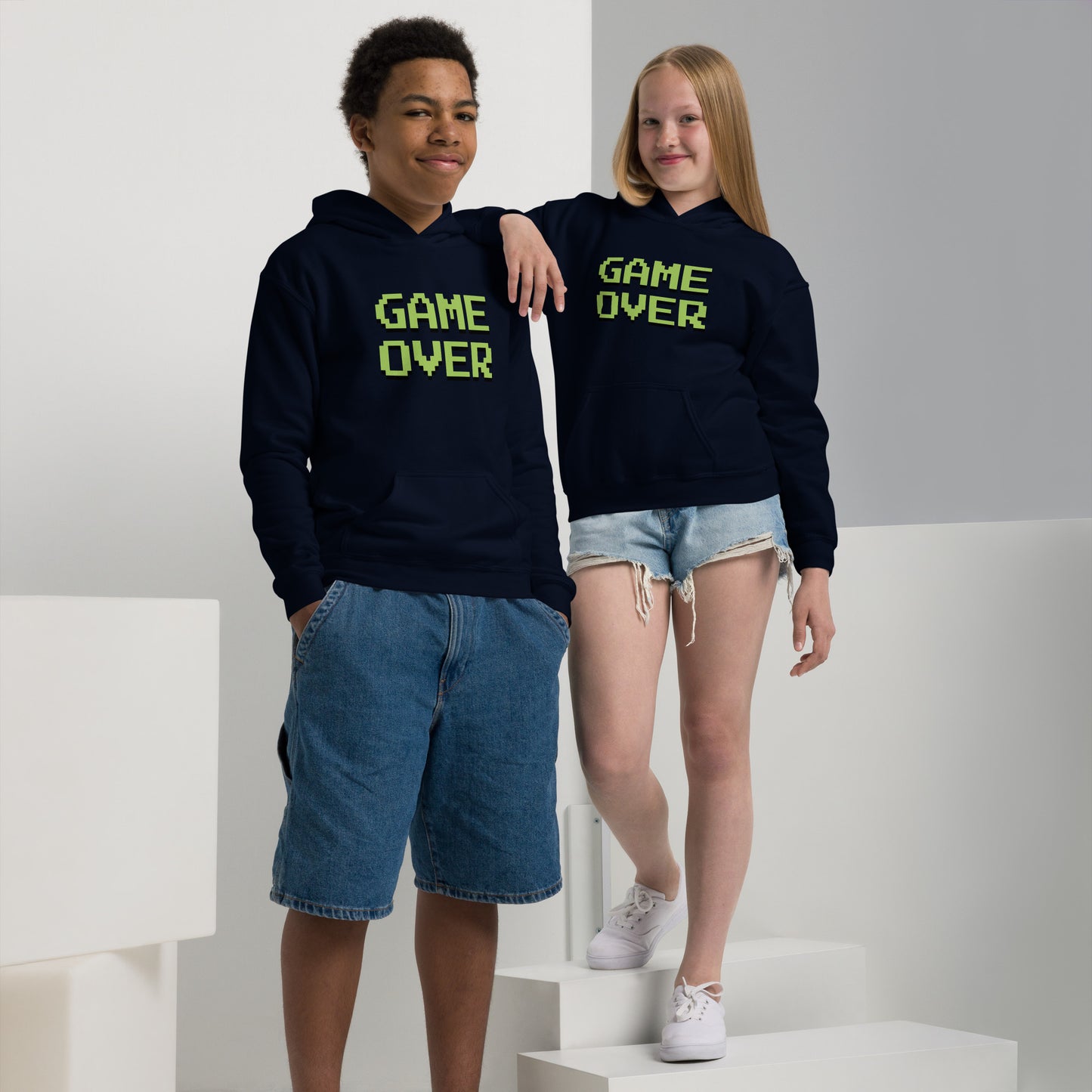 Youth with navy hoodie with the text GAME OVER in green