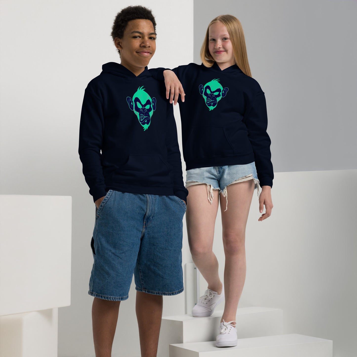 Boy and girl with navy hoodie and print of a Cool monkey in black light green