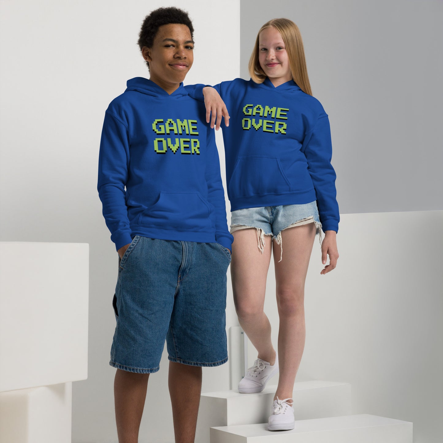 Youth with royal blue hoodie with the text GAME OVER in green