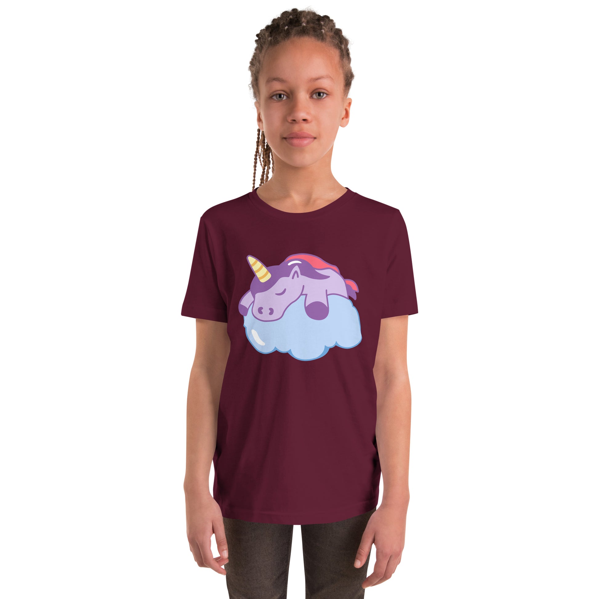 Youth with a maroon T-shirt with a print of a sleeping unicorn on a cloud