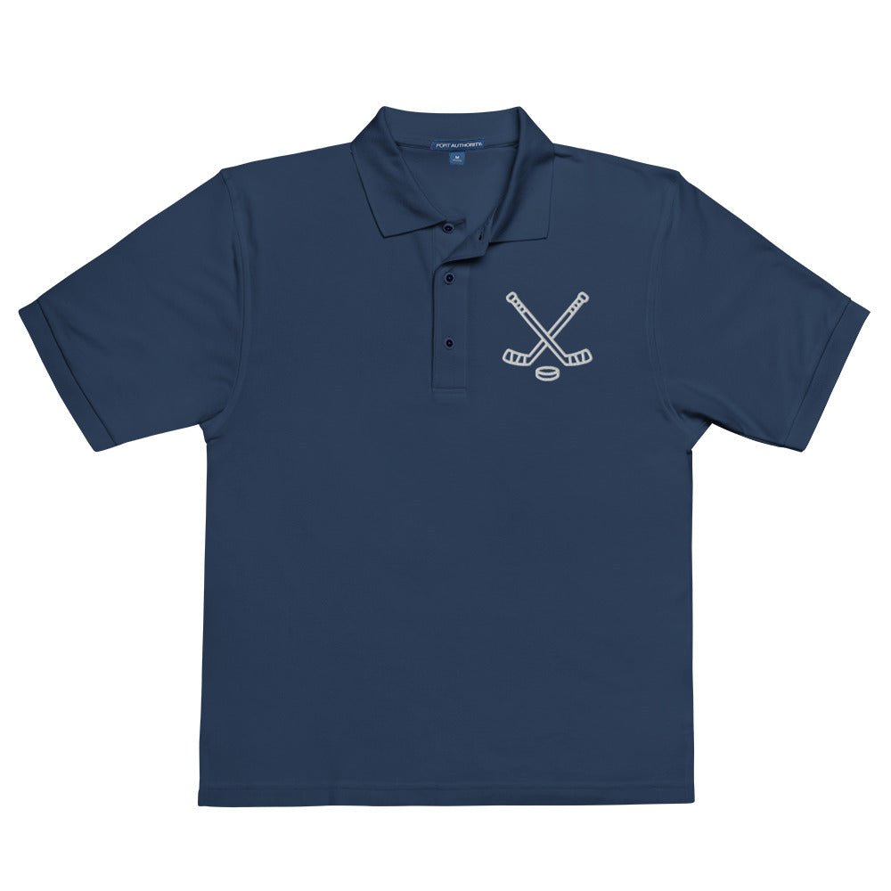 Navy poloshirt with print of hockeysticks and puk